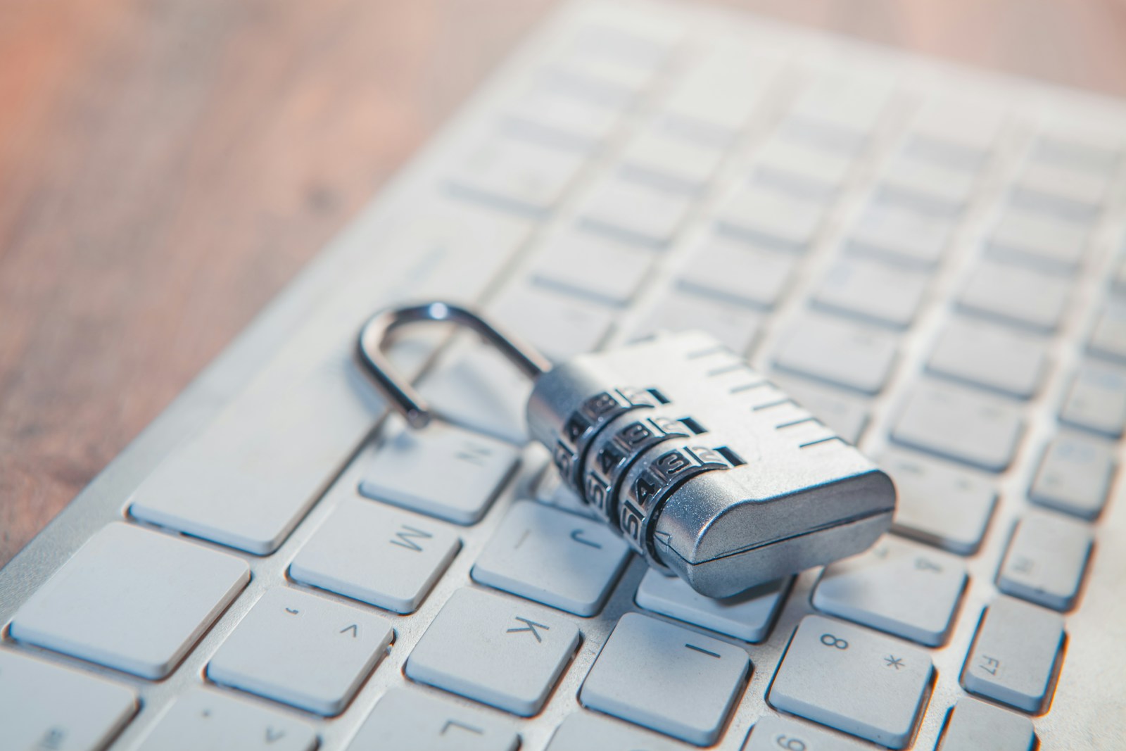 A combination lock on a keyboard representing data privacy controls.
